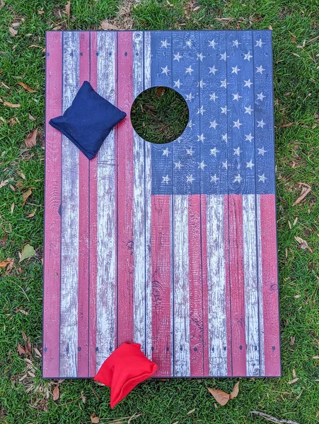Red, white, and blue cornhole game at the BBQ