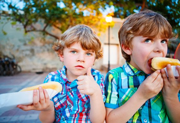 Kids enjoying hotdogs at the Family Fun Night BBQ