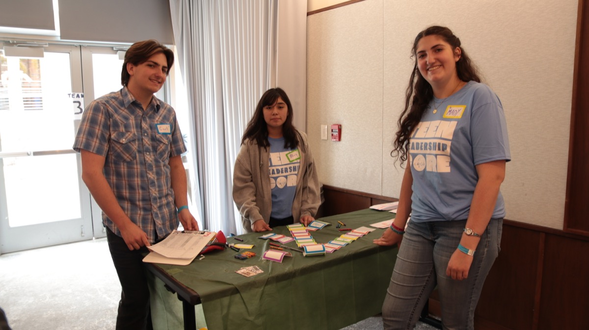 Teen Leadership Core volunteers at service table